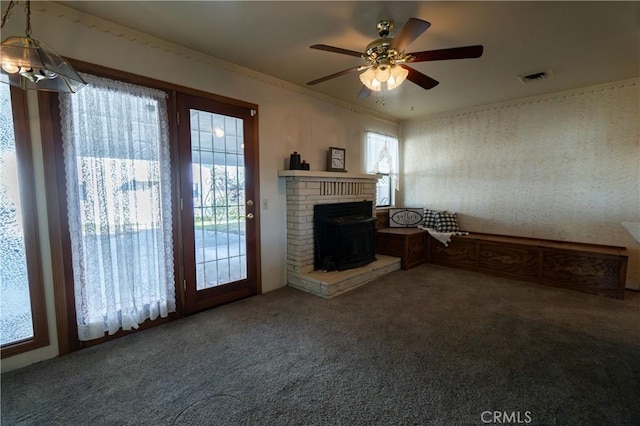 unfurnished living room featuring carpet floors and ceiling fan