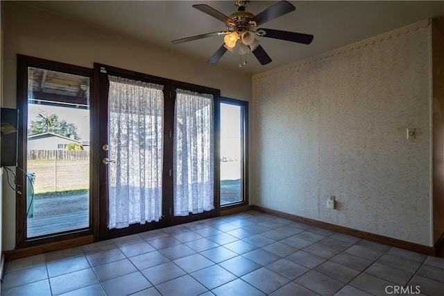 spare room with light tile patterned flooring and ceiling fan