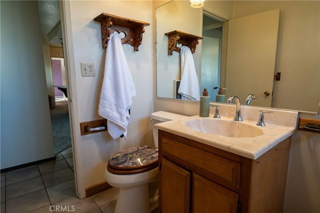 bathroom with vanity, tile patterned floors, and toilet