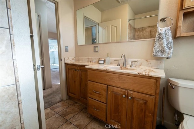 bathroom featuring vanity, toilet, and tile patterned flooring