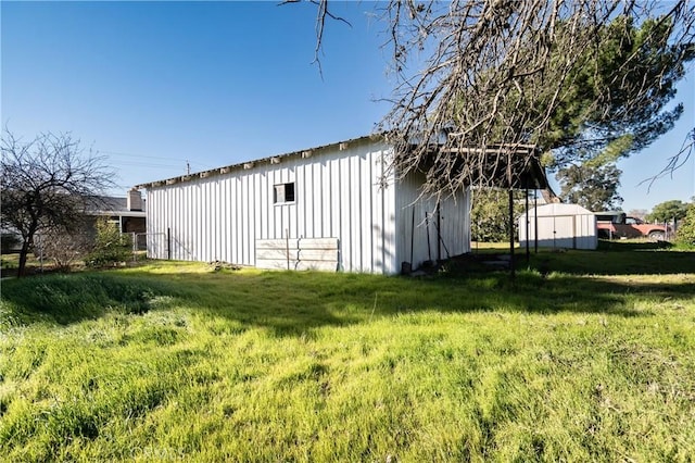 view of outbuilding with a lawn