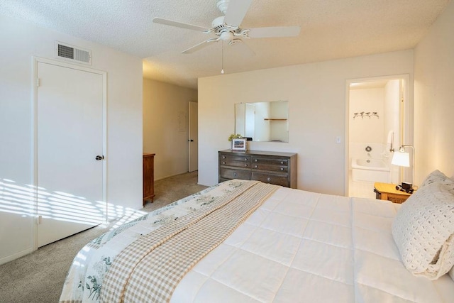 carpeted bedroom featuring ceiling fan, a textured ceiling, and connected bathroom