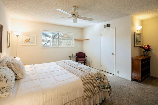 bedroom with carpet, a textured ceiling, and ceiling fan