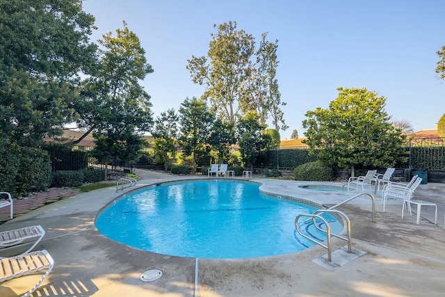 view of pool with a patio area and a community hot tub