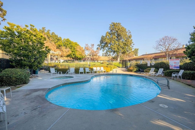 view of pool featuring a patio area and a community hot tub