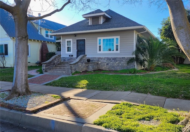 bungalow-style home featuring a front lawn