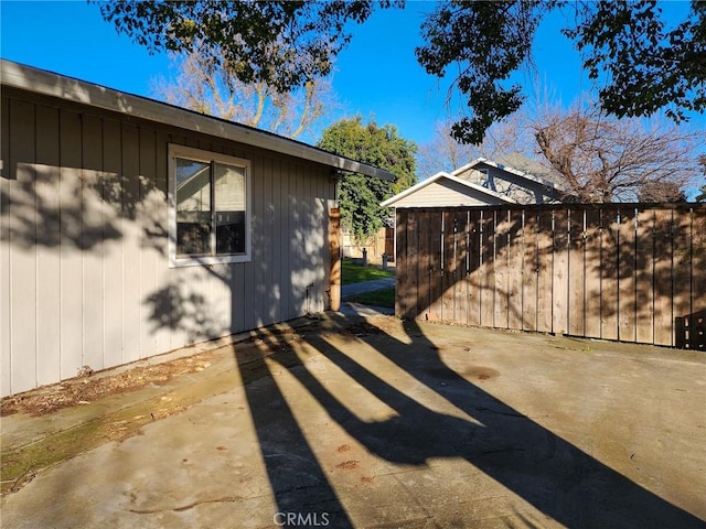 view of side of property with a patio area