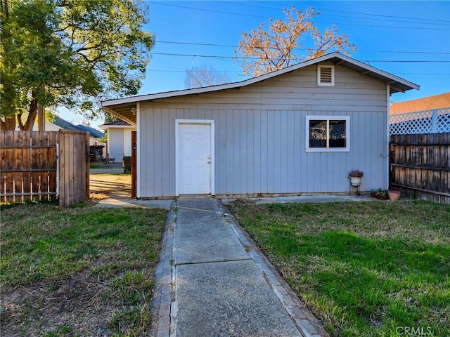 view of outbuilding featuring a lawn