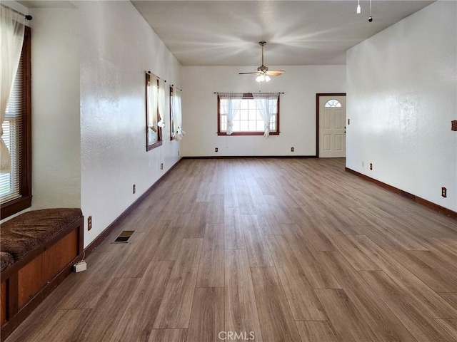 empty room featuring light wood-type flooring and ceiling fan