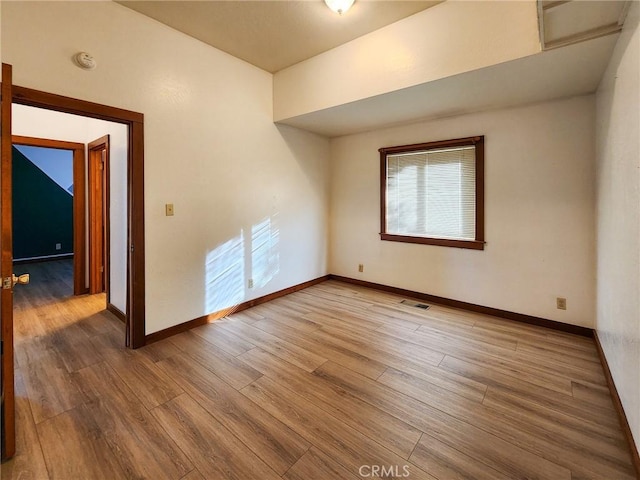 unfurnished room with hardwood / wood-style flooring