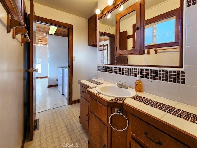 bathroom featuring tasteful backsplash, ceiling fan, and vanity