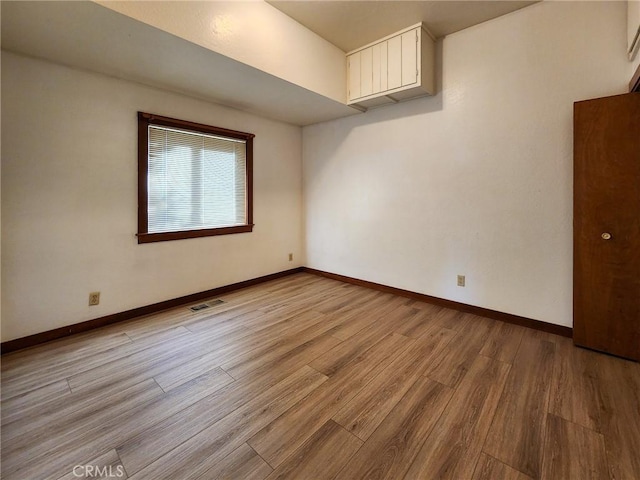 spare room with light hardwood / wood-style floors