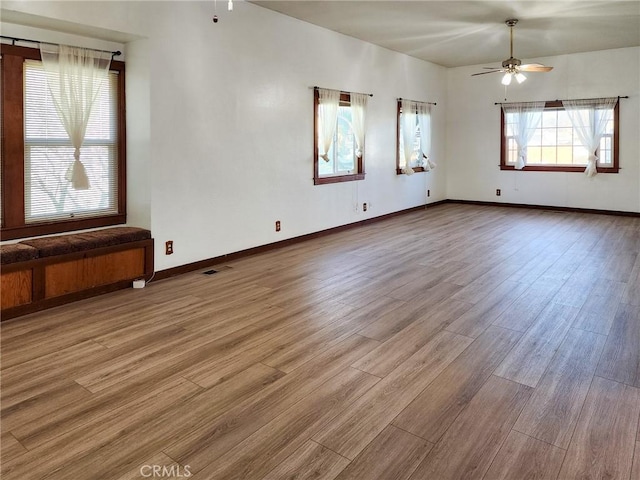 unfurnished room featuring light hardwood / wood-style flooring and ceiling fan