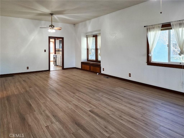 spare room with ceiling fan and wood-type flooring