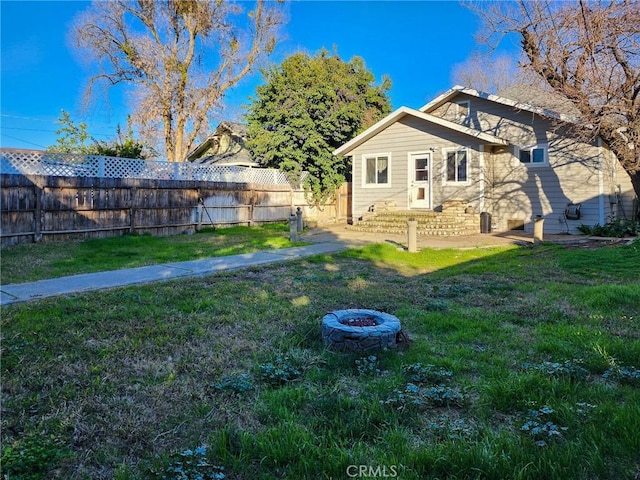 view of yard with a fire pit