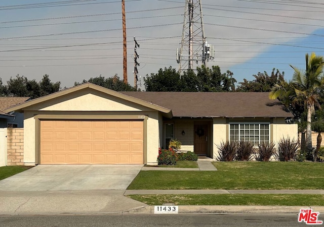 ranch-style house with a front lawn and a garage