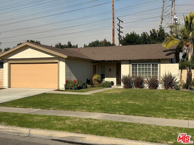 ranch-style home featuring a garage and a front lawn