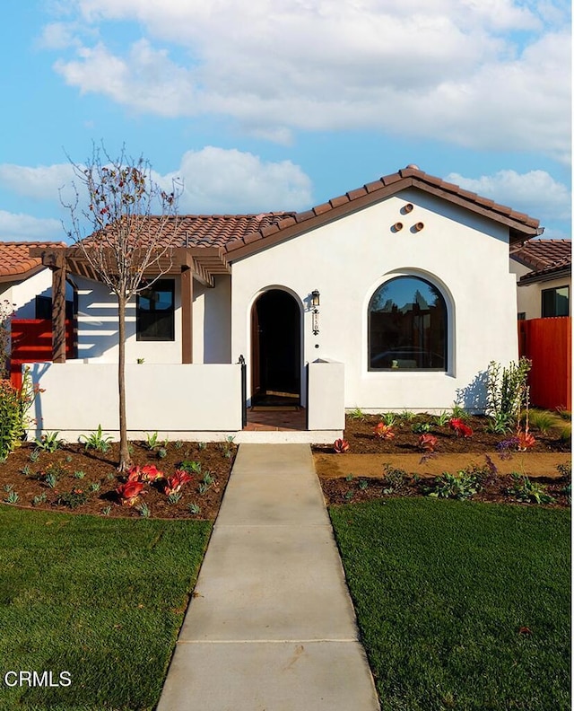 mediterranean / spanish-style home featuring a front yard