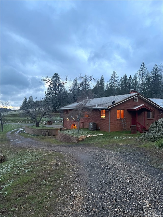 ranch-style house with central AC unit