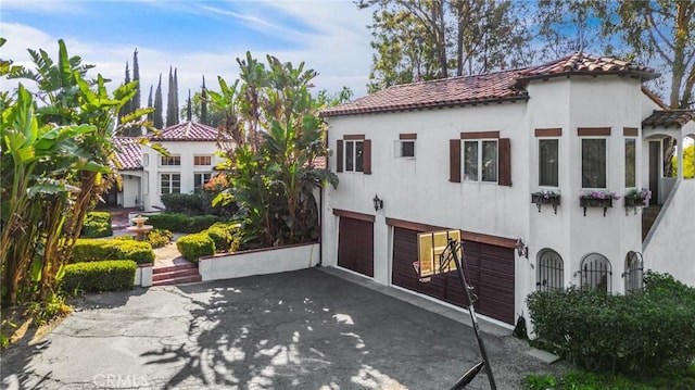 mediterranean / spanish home with a garage