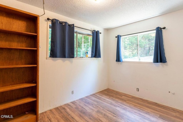 unfurnished bedroom featuring hardwood / wood-style flooring and a textured ceiling