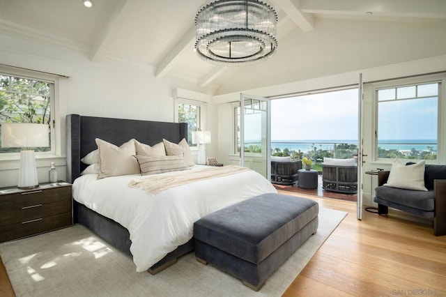 bedroom with vaulted ceiling with beams, a water view, light hardwood / wood-style flooring, and an inviting chandelier