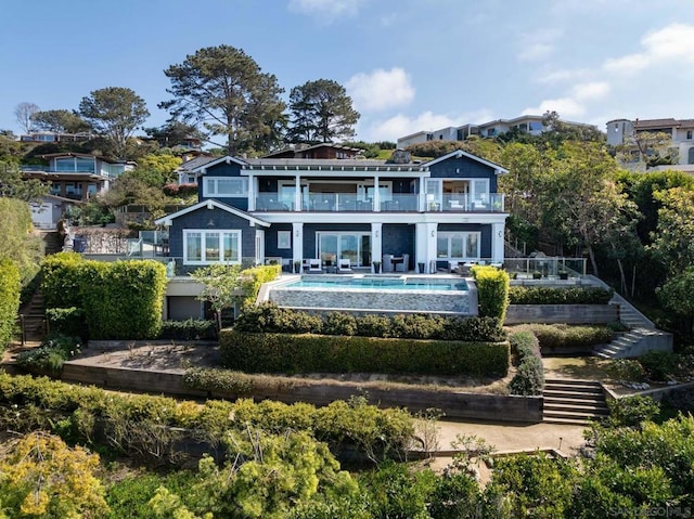 back of house featuring a balcony