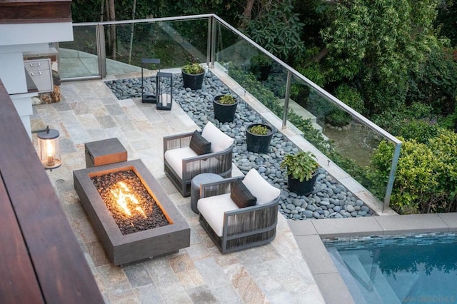 view of patio / terrace with an outdoor living space with a fire pit