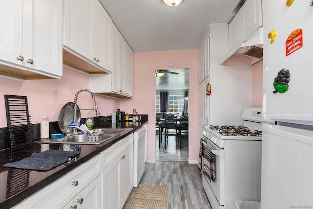 kitchen featuring white cabinets, light hardwood / wood-style floors, white appliances, and sink