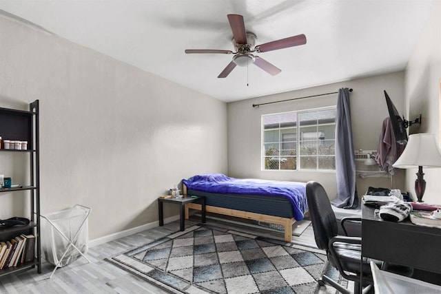 bedroom featuring hardwood / wood-style flooring and ceiling fan