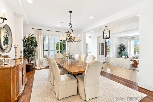 dining space featuring light hardwood / wood-style floors and a notable chandelier