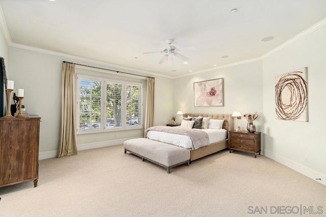 carpeted bedroom with ceiling fan and ornamental molding