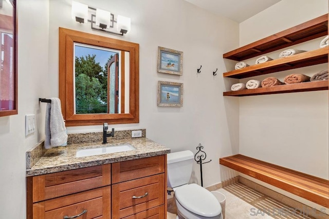 bathroom featuring vanity and toilet