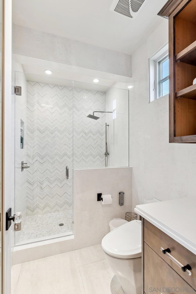 bathroom with walk in shower, tile patterned flooring, and toilet