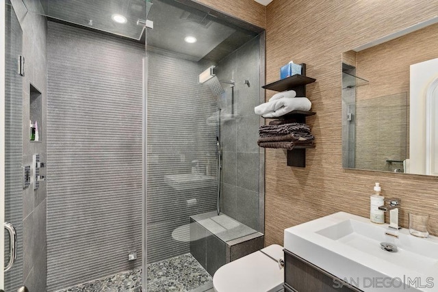 bathroom with vanity, toilet, and an enclosed shower