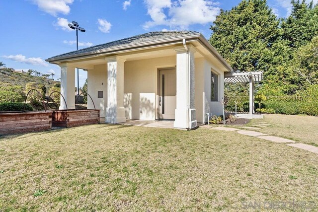 rear view of property with a yard