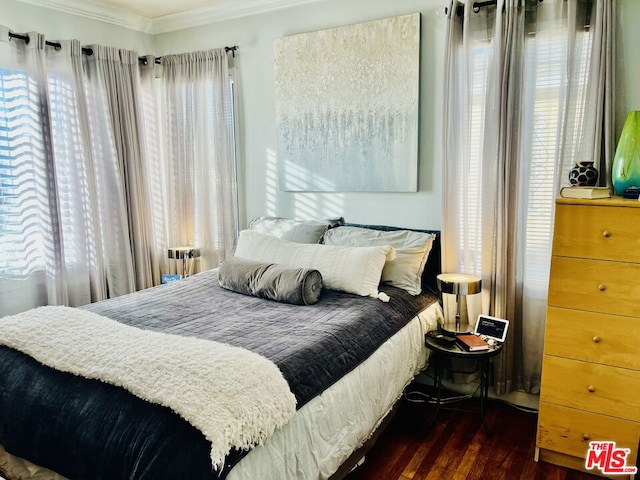 bedroom featuring dark wood-type flooring and ornamental molding