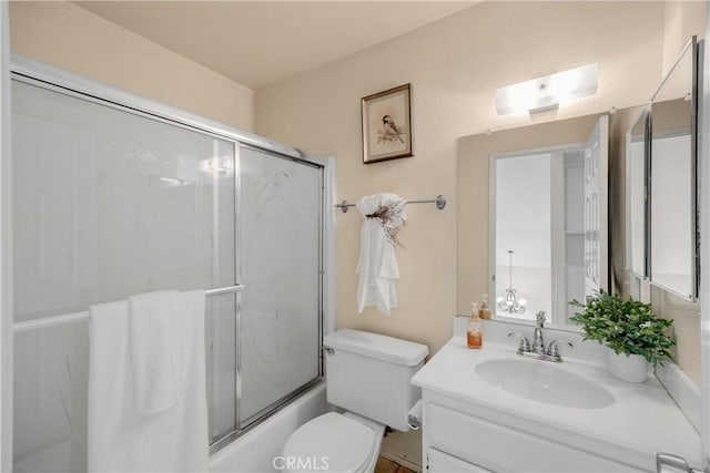 full bathroom featuring vanity, toilet, bath / shower combo with glass door, and a skylight