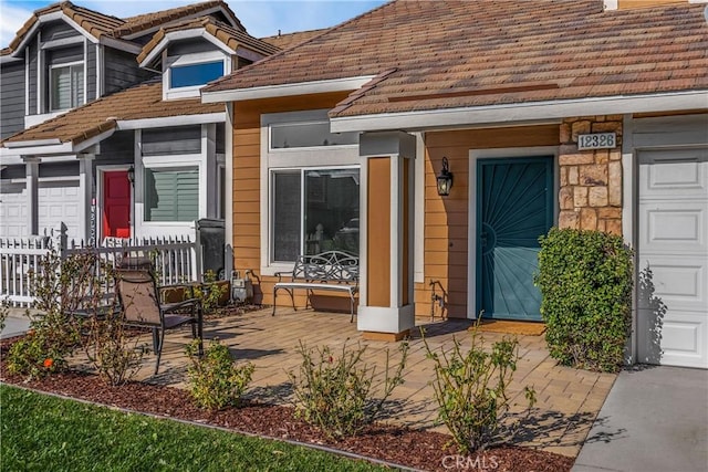 property entrance featuring a porch and a garage