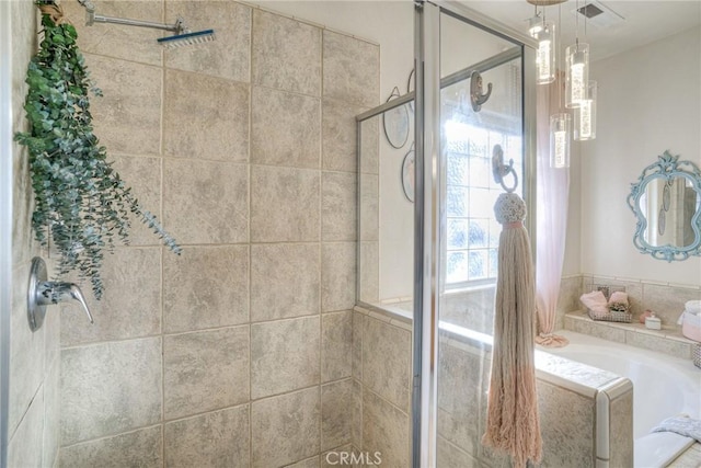 bathroom with plus walk in shower and a healthy amount of sunlight