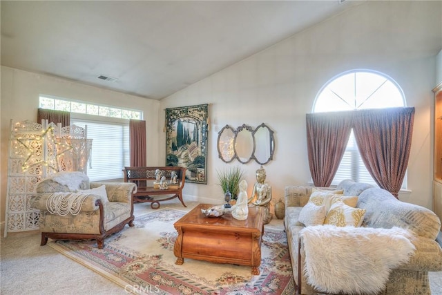 living room featuring carpet flooring and lofted ceiling