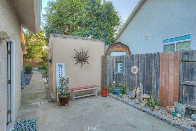 view of patio featuring a storage unit