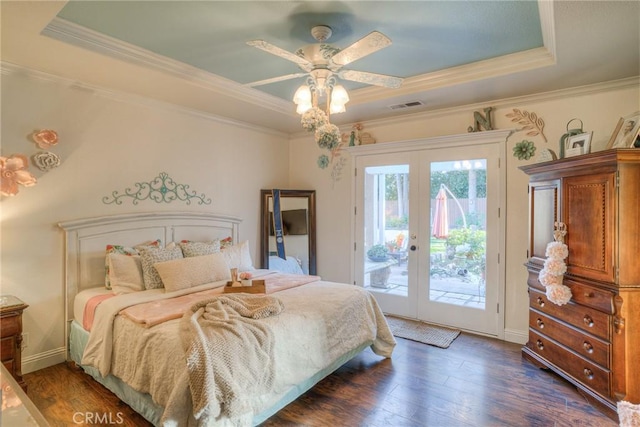 bedroom featuring french doors, access to outside, a raised ceiling, ceiling fan, and dark wood-type flooring