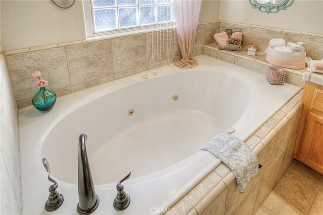 bathroom featuring tile patterned floors and a relaxing tiled tub