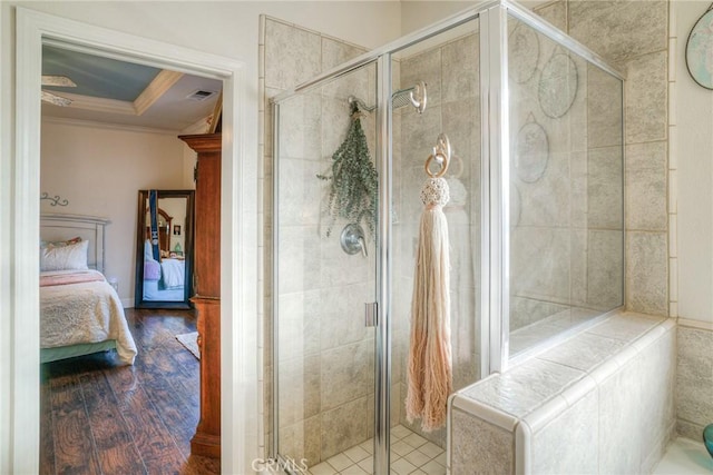 bathroom featuring crown molding, hardwood / wood-style floors, and an enclosed shower