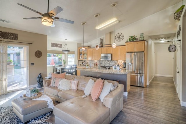 living room with ceiling fan, dark hardwood / wood-style flooring, and lofted ceiling