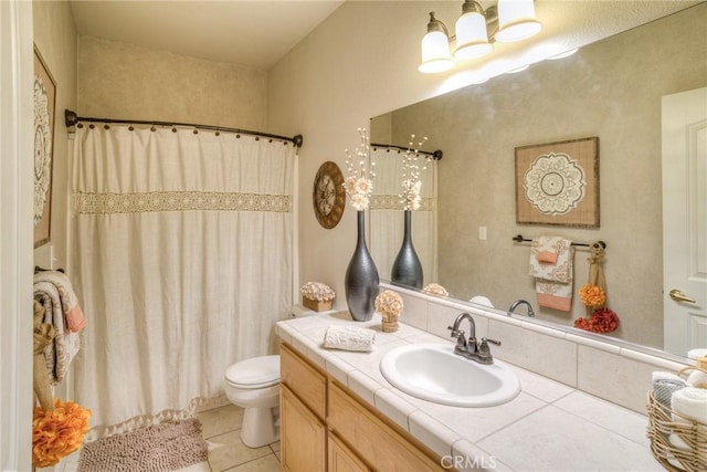 bathroom featuring tile patterned flooring, vanity, curtained shower, and toilet