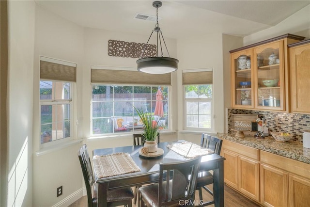 dining space with dark hardwood / wood-style floors