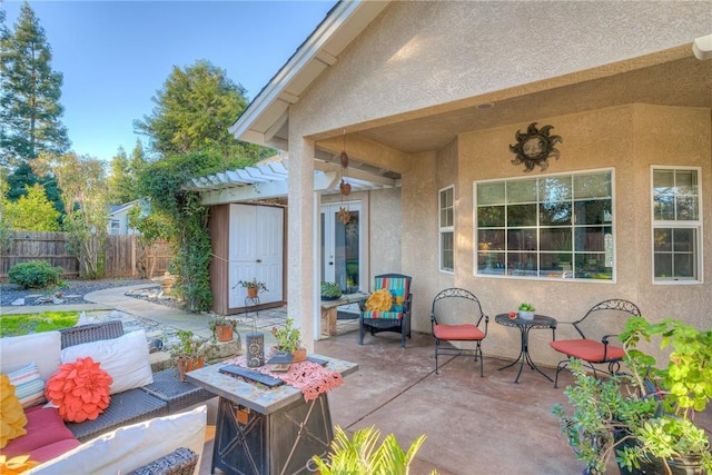 view of patio / terrace with a pergola and an outdoor living space with a fire pit