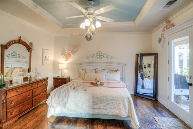 bedroom featuring access to exterior, ceiling fan, dark hardwood / wood-style flooring, crown molding, and a tray ceiling